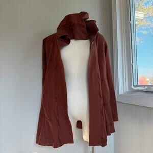 Brown burnt orange hooded cardigan with slightly flared sleeves and pockets